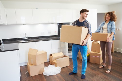 Trained movers carrying boxed items carefully in a Vauxhall relocation