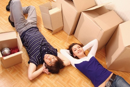 Professional movers handling furniture in a Vauxhall apartment building